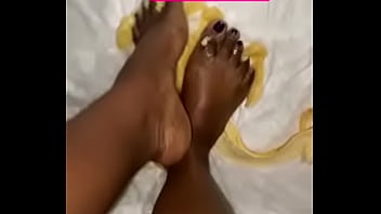 Pretty ebony feet plays with banana